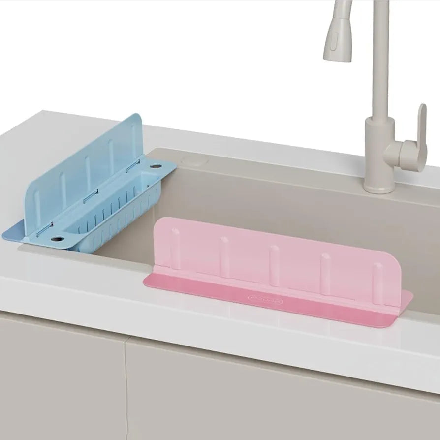 Pink and blue dish drying racks on a kitchen sink