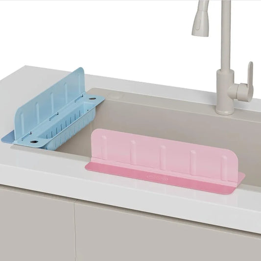 Pink and blue dish drying racks on a kitchen sink