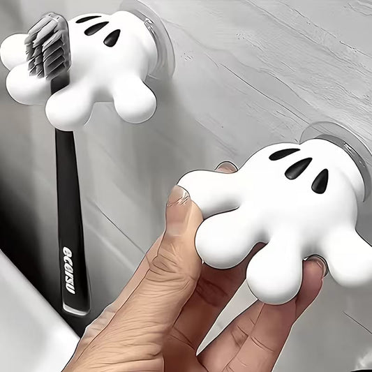 Cute palm-shaped suction cup bathroom hook holding a hand towel on a tiled wall